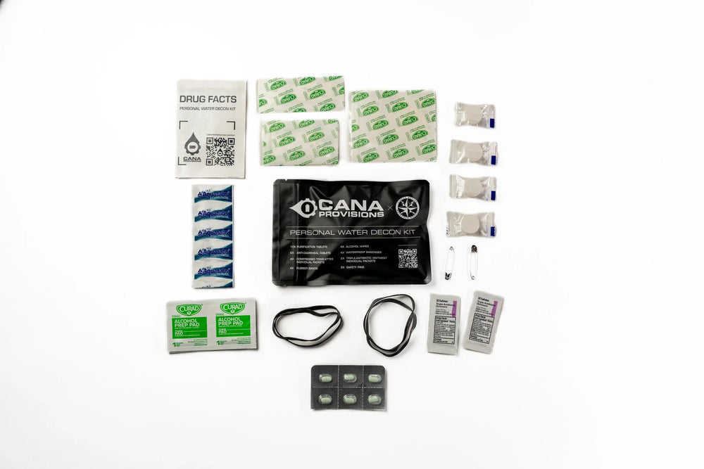 CANA Provisions Personal Water Decon Kit flat-lay of black pouch, Aquatabs, bandages, pills and QR-coded card