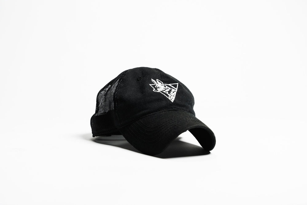 Black Team Cap, three-quarter front view showing white embroidered painted dog logo, mesh back panel and curved bill