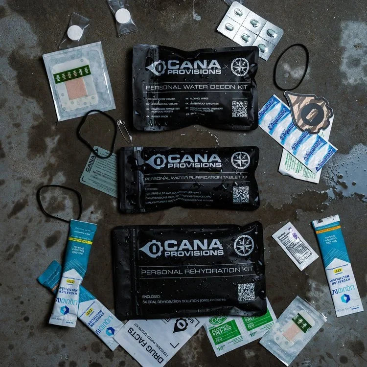CANA Personal Decon Combo Kit flat-lay on wet concrete, three black CANA Provisions pouches with contents spread out