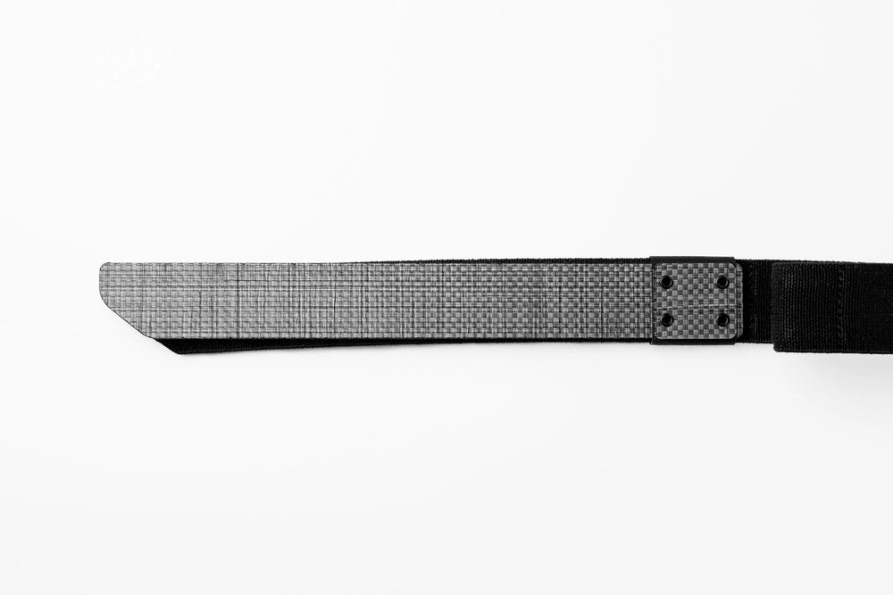Every Day Belt flat-lay close-up: tapered gray crosshatch strap end riveted to black webbing at carbon-look plate