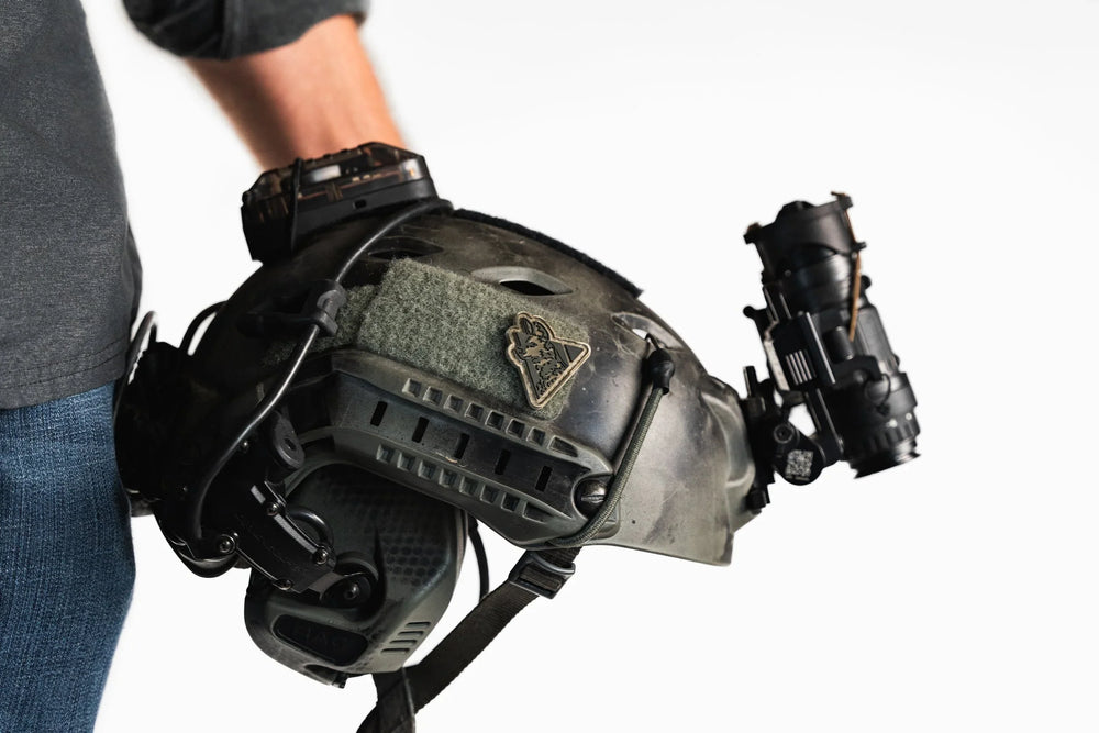 Dirty Civilian Logo Patch, tan triangular wolf head design on the velcro panel of a black tactical helmet