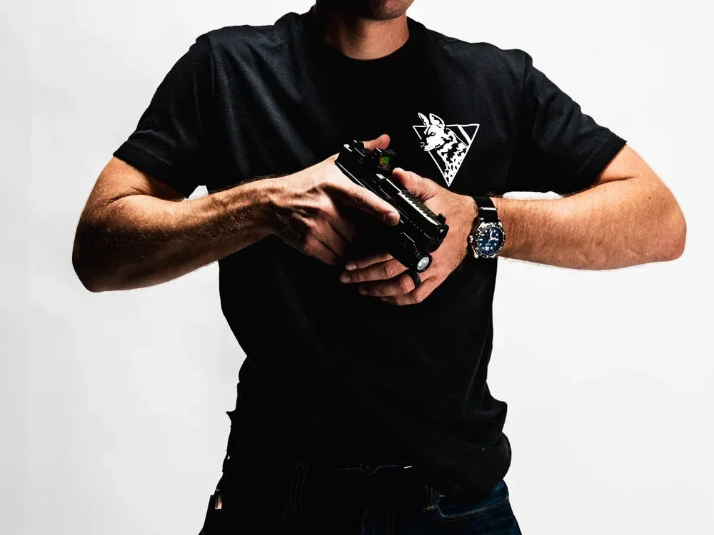 Dirty Civilian black tee worn on-body, front view with white African Painted Dog triangle chest logo