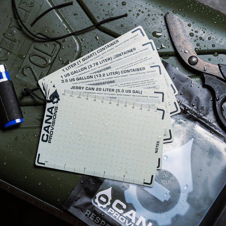 CANA Water Data Card Core Kit fanned out on a wet olive jerry can, cards showing dosing charts and CANA Provisions logo